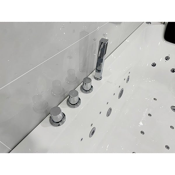 Close-up of a bathtub with faucet and control knobs of Cascada Amalfi 67-inch freestanding whirlpool bathtub in luxury bathroom