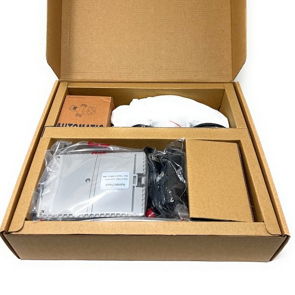 Open cardboard box containing electronic components and packaging