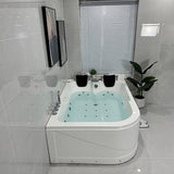 Modern bathroom with a Jacuzzi bathtub, tiled walls, and a window.