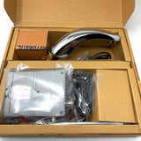 Boxed set containing a chrome sensor faucet spout, electronic control unit, and accessories in cardboard packaging.